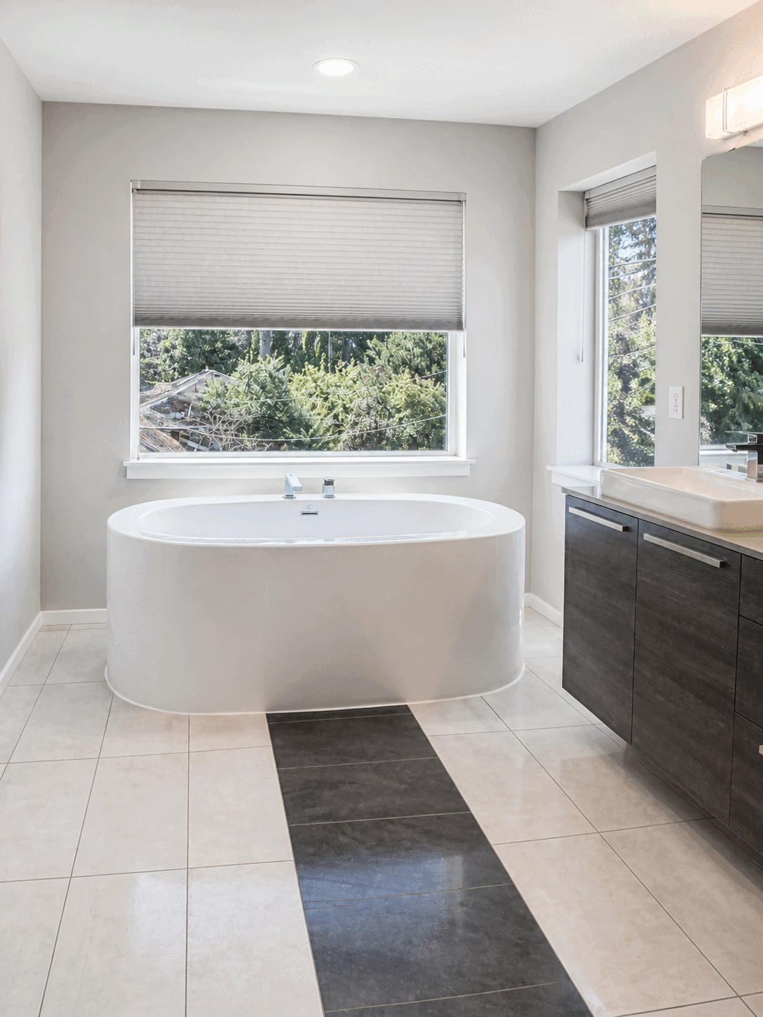 Polished freestanding bathtub and tile floor after regular cleaning