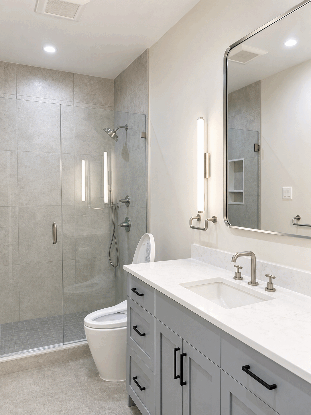 Bright grey bathroom with polished vanity and glass shower
